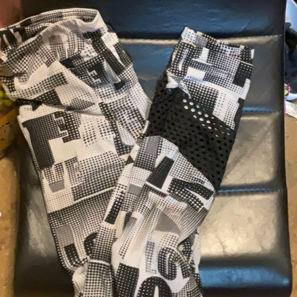 Black, white and gray capris with see-through section at ankle height